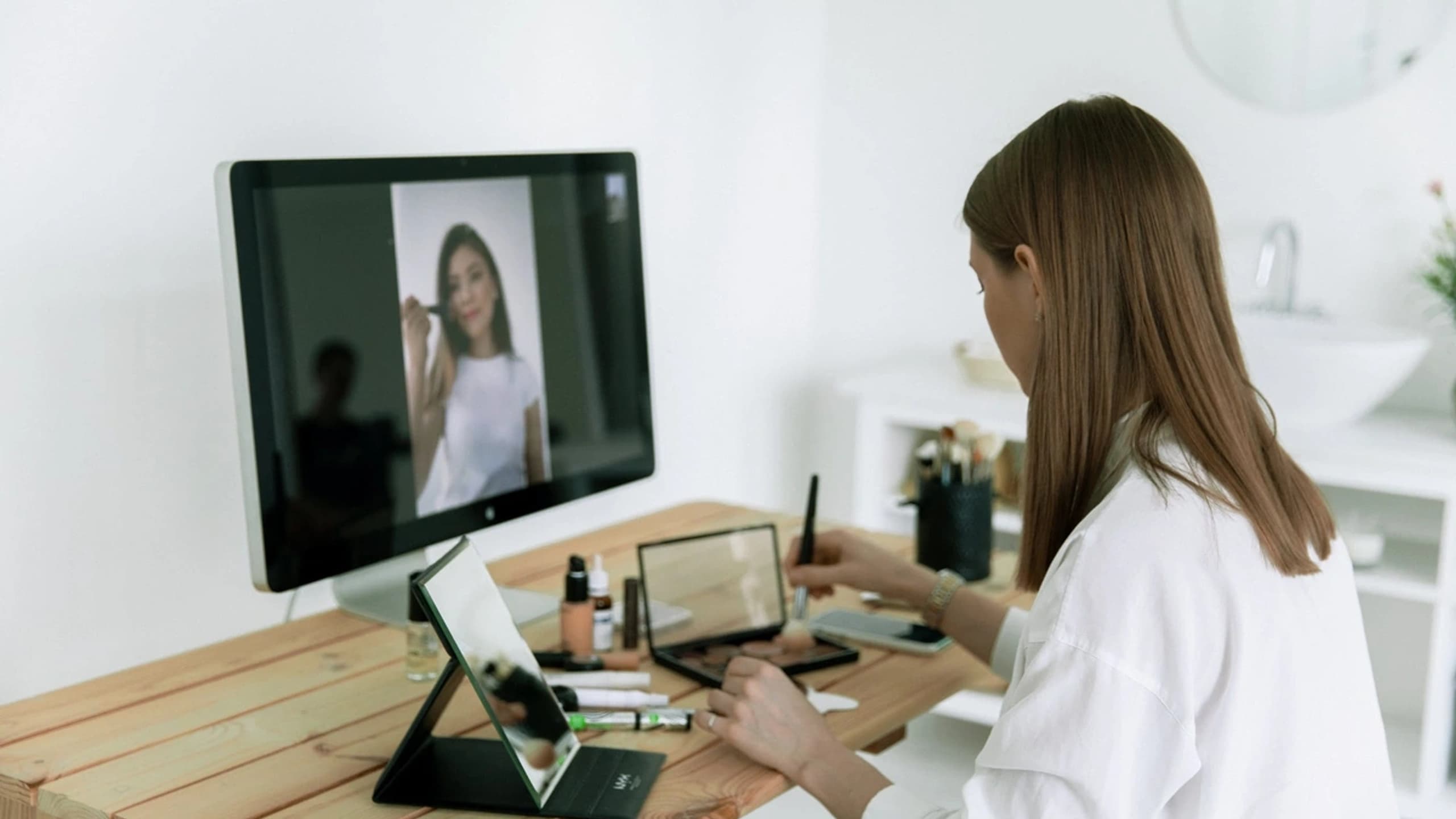 Woman looking at computer screens and workstation set-up