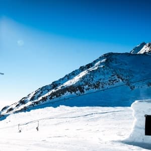 Man jumping over hurdle while skiing