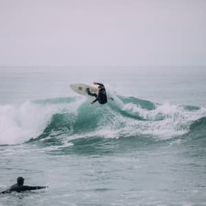 Surfer on wave in New Zealand