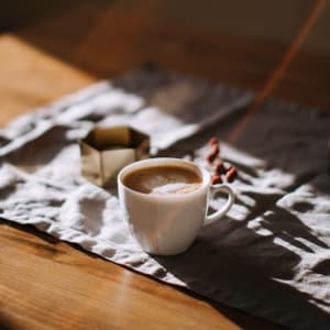 Coffee cup on table in sunlight