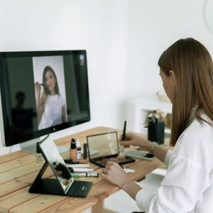 Woman looking at computer screens and workstation set-up